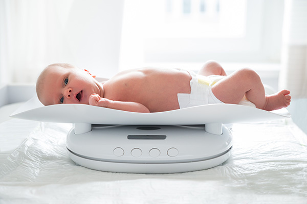 Image of a baby being weighed